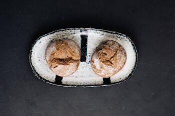 Close-up of two sourdough breads on a stylish ceramic plate, ideal for food photography.