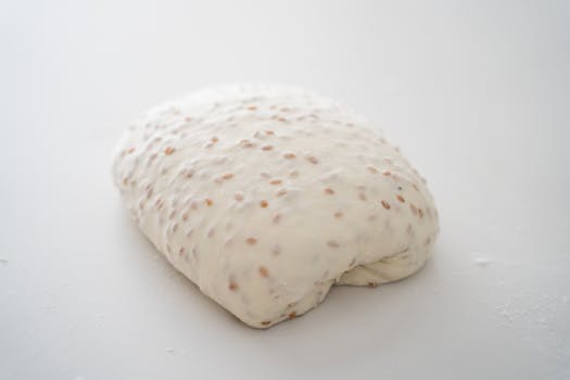 High-quality image of raw dough with seeds, perfect for bakery and food topics.
