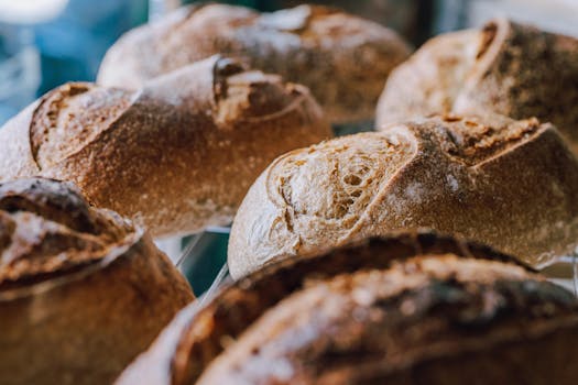 Rustic artisanal bread loaves with golden crusts displayed in a Buenos Aires bakery.